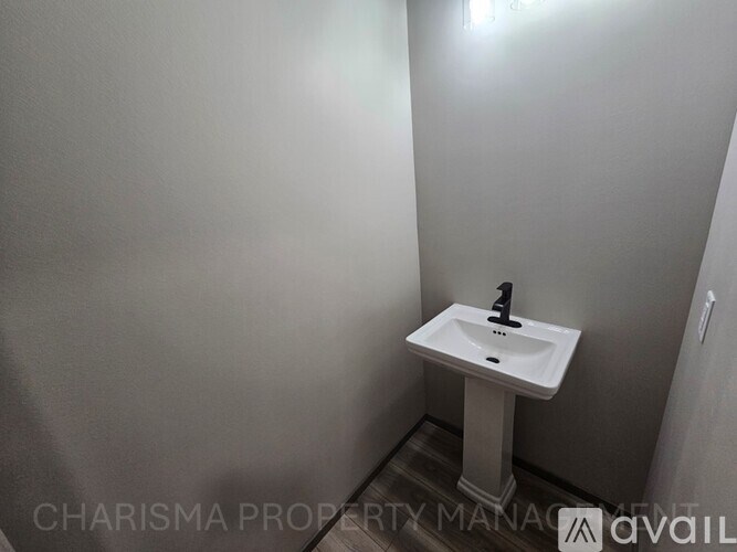 A white sink in a small bathroom.