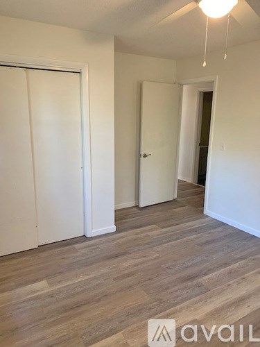 A room with a white door and a white wall.