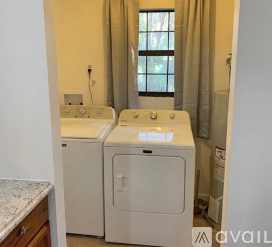 A small laundry room with a washer and dryer.