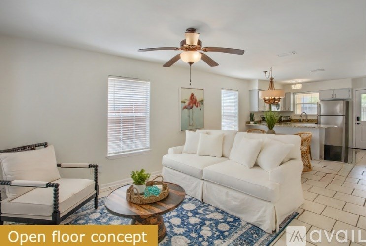 A living room with a white sofa and a wooden coffee table.