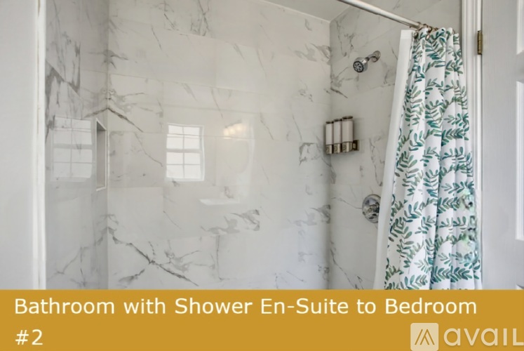 A bathroom with a shower en-suite leading to a bedroom.