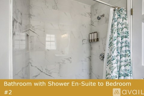 A bathroom with a shower en-suite leading to a bedroom.