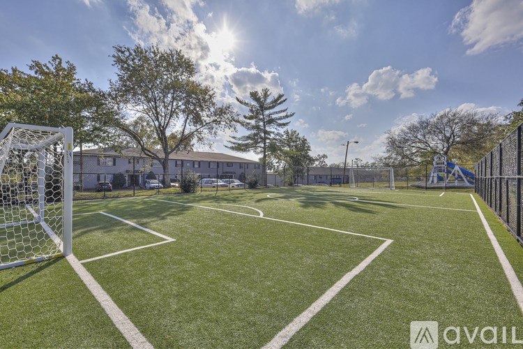 A soccer field with a goal post on the left side.