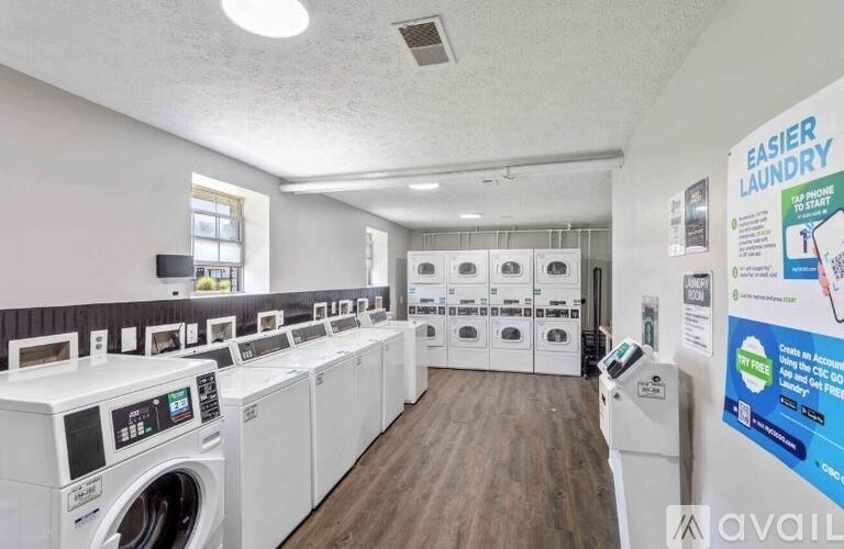 A laundry room with rows of washing machines.