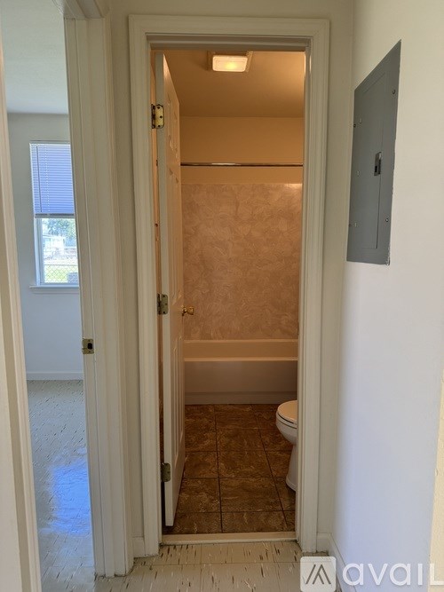A bathroom with a toilet and a shower stall.