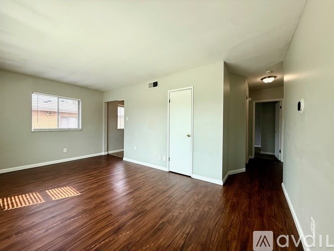 A room with wooden floors and white walls.