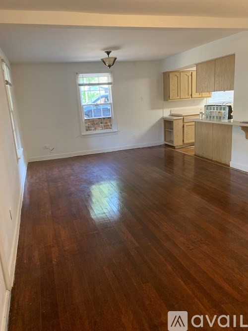 A room with wooden floors and a window.