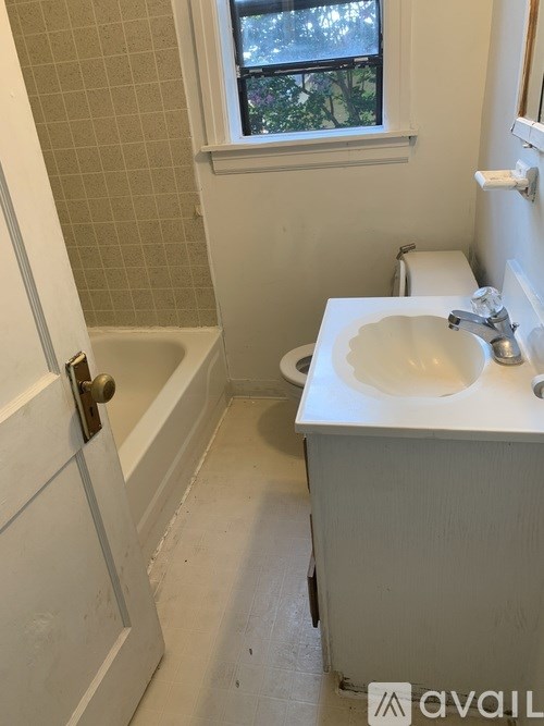 A bathroom with a white sink and a white toilet.