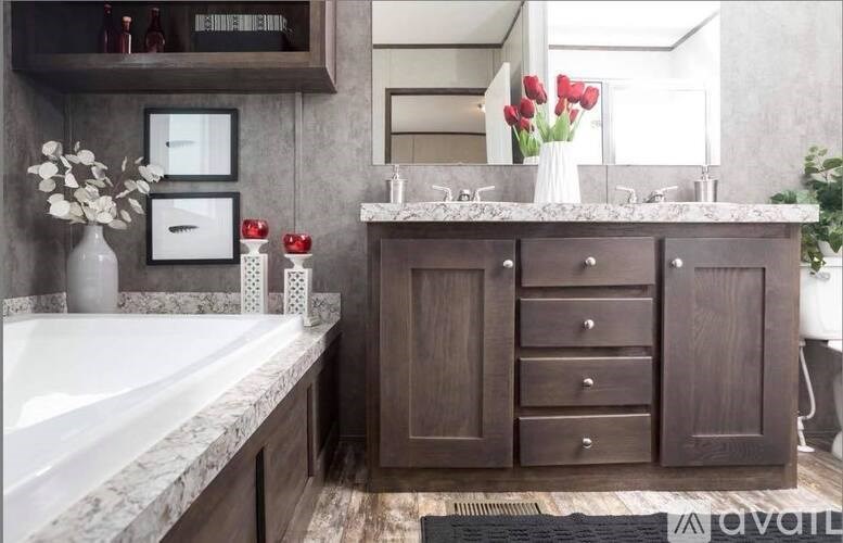A bathroom with a marble countertop and a white bathtub.