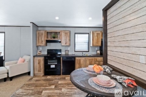 A modern kitchen with wooden cabinets and a black stove top oven.