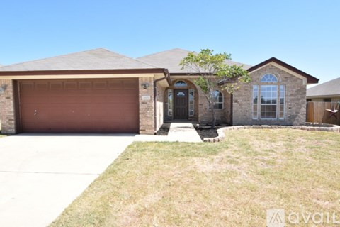 A house with a brown garage door is for sale.