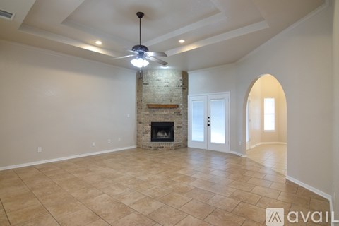A large bathroom with a tub and double sinks.