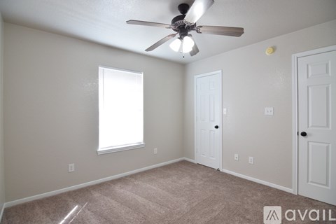 A bathroom with a toilet, sink and wooden cabinet.