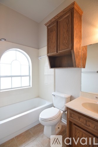 A room with a ceiling fan and a white door.