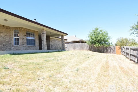 A house with a fence in front of it.