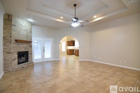 A room with a ceiling fan and a window.