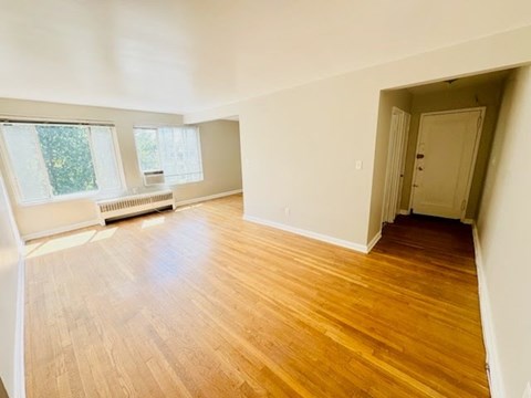 A room with wooden floors and white walls.