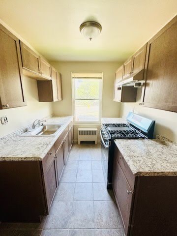 A kitchen with brown cabinets and a granite counter top.