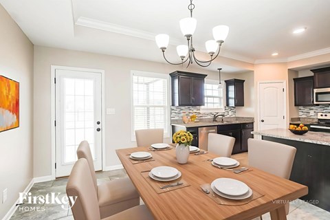 A dining room with a wooden table set for a meal.