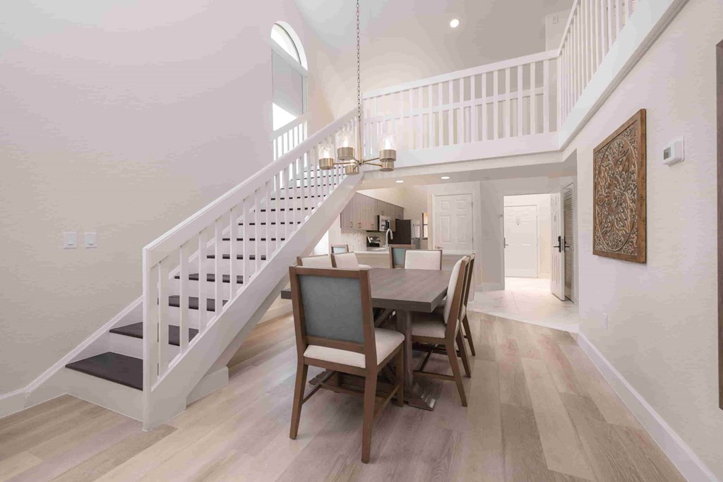 A dining room with a wooden table and chairs.