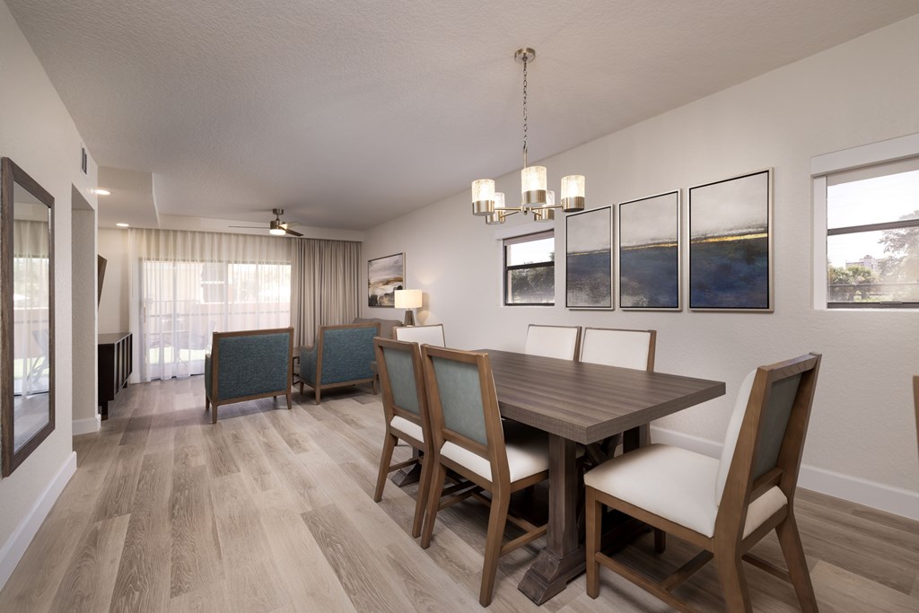 A dining room with a wooden table and chairs.