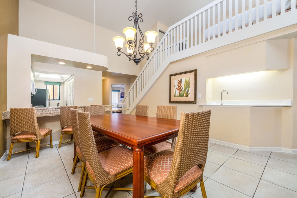 A dining room with a wooden table and chairs.
