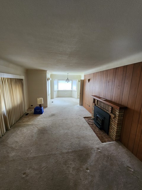A room with a fireplace and a window.