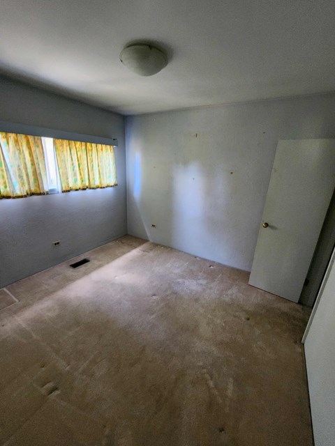 A room with a window and a door.