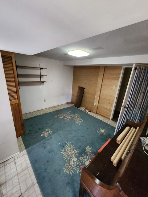 A room with a wooden floor and a wooden chair.