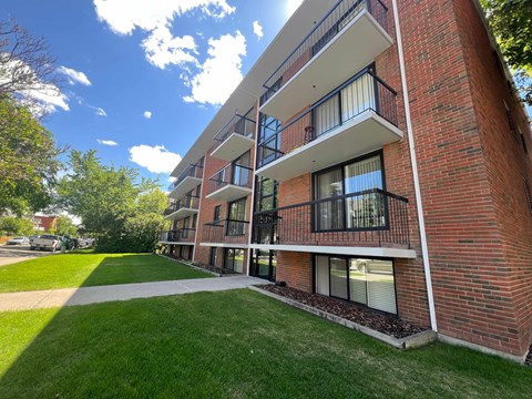 A red brick building with a balcony on the second floor.
