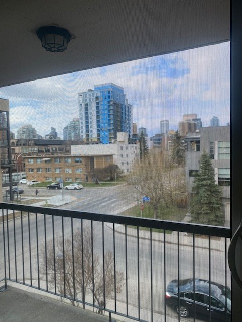A black car is parked on the street below.