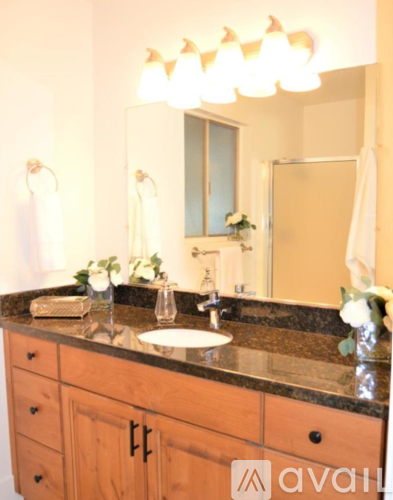 A bathroom with a sink and a mirror.
