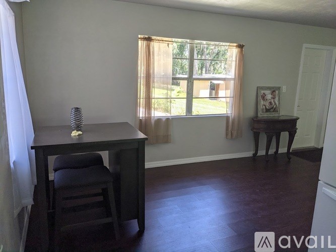 A room with a desk and chair in it.