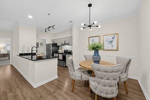 A modern kitchen with a dining table and chairs.