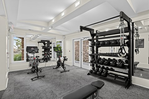 A spacious home gym with a variety of exercise equipment.