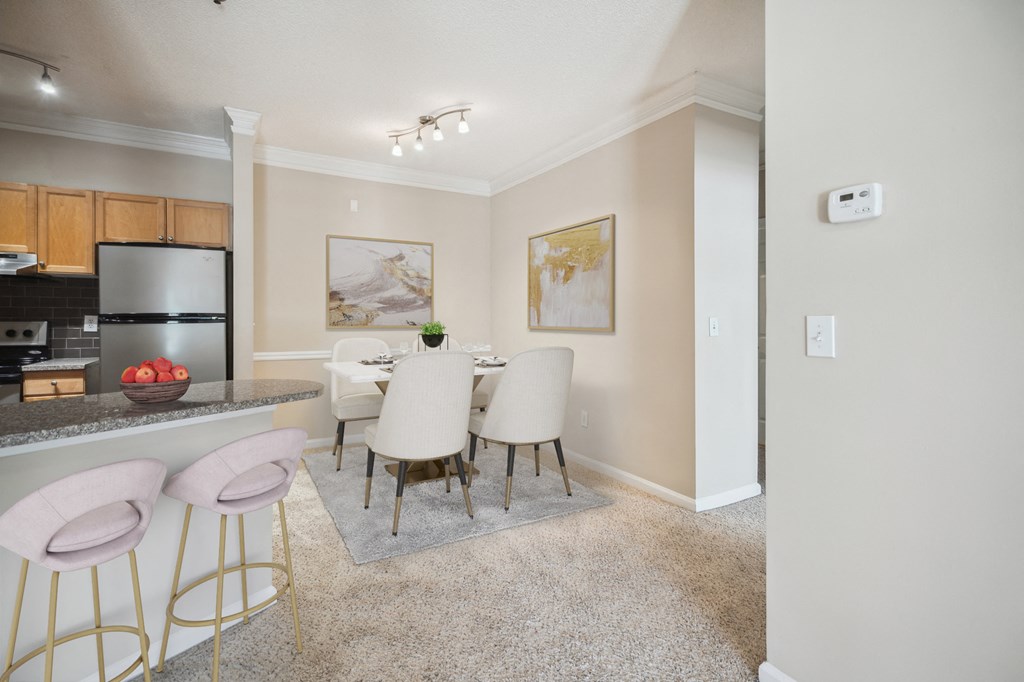 a dining room with a table and chairs and a kitchen