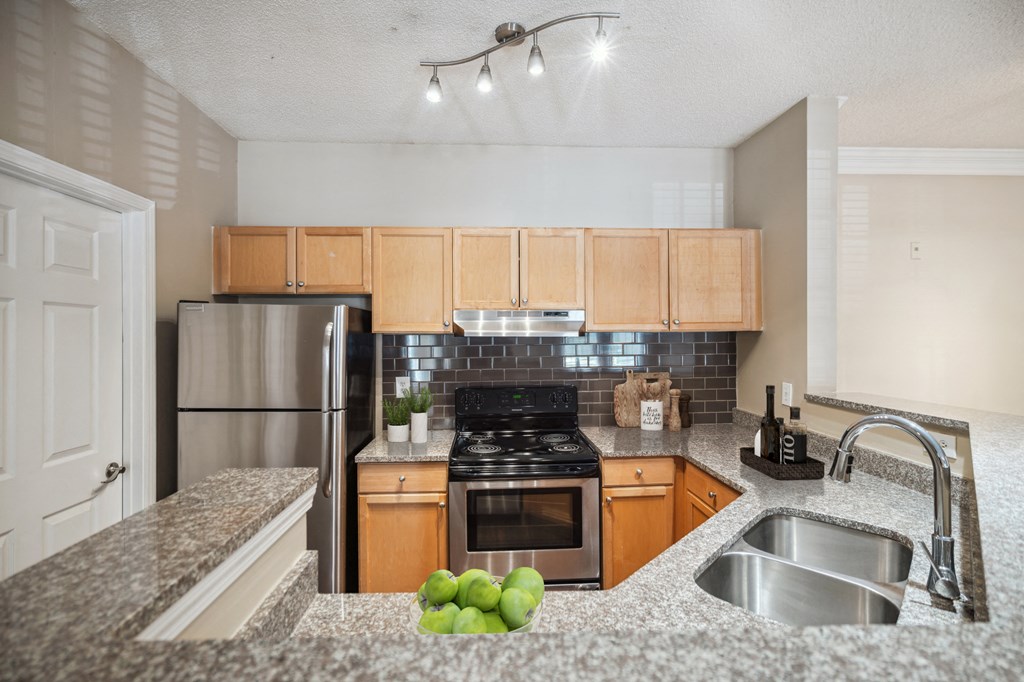 a kitchen with granite counter tops and stainless steel appliances
