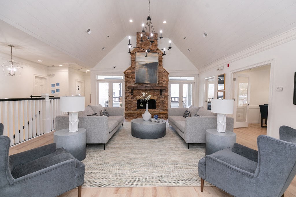 a living room with couches and chairs and a fireplace