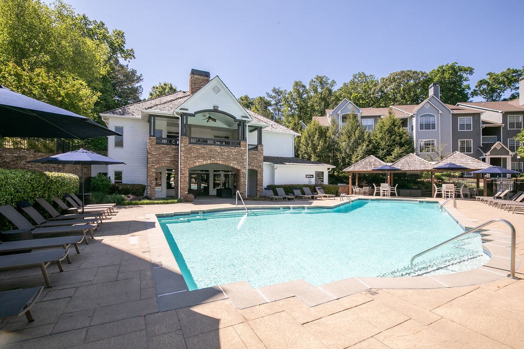 apartments with a swimming pool and patio with chairs