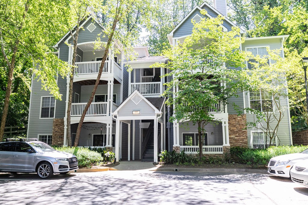 a large house with cars parked in front of it