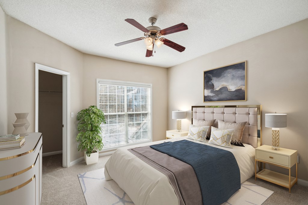 a bedroom with a ceiling fan and a bed