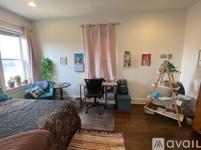 A room with a bed, desk, and chair.