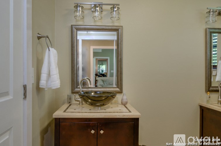 A bathroom with a sink and mirror.