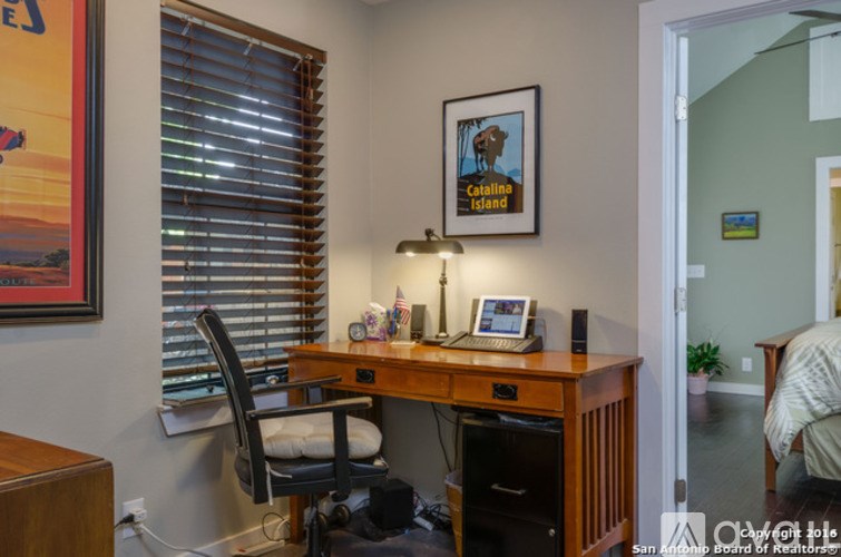 A Callaway Island poster is on the wall above a wooden desk.