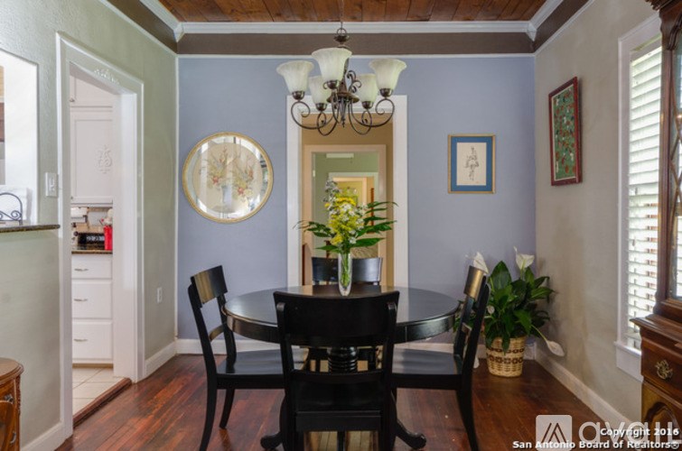 A dining room with a table and chairs.