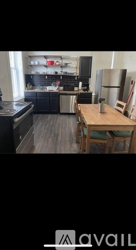 A kitchen with a wooden table and chairs.