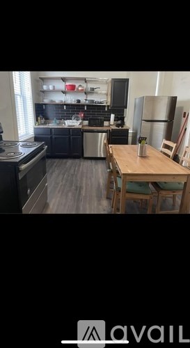 A kitchen with a wooden table and chairs.