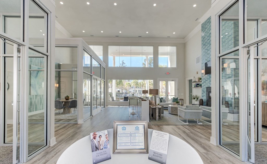 a large living room with glass doors and a table
