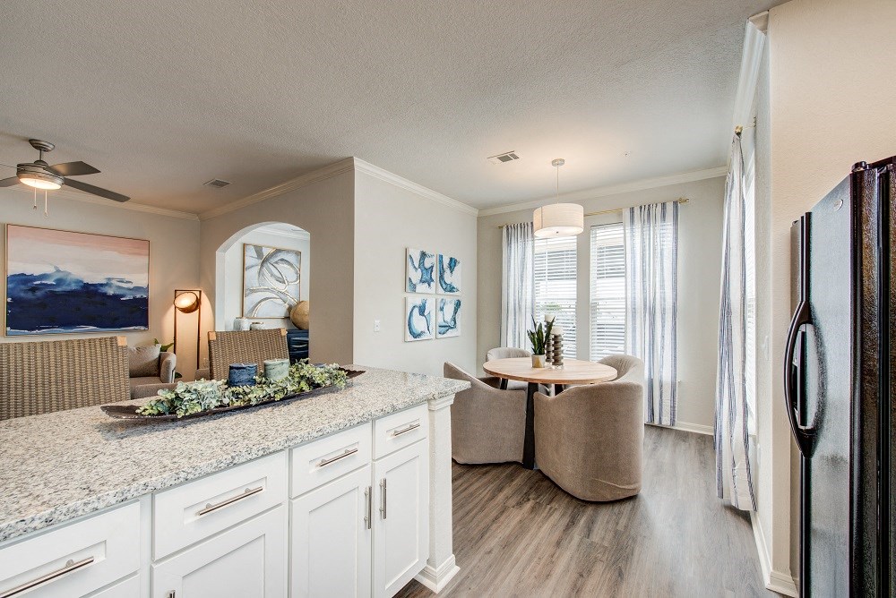 an open kitchen and living room with a couch and a table