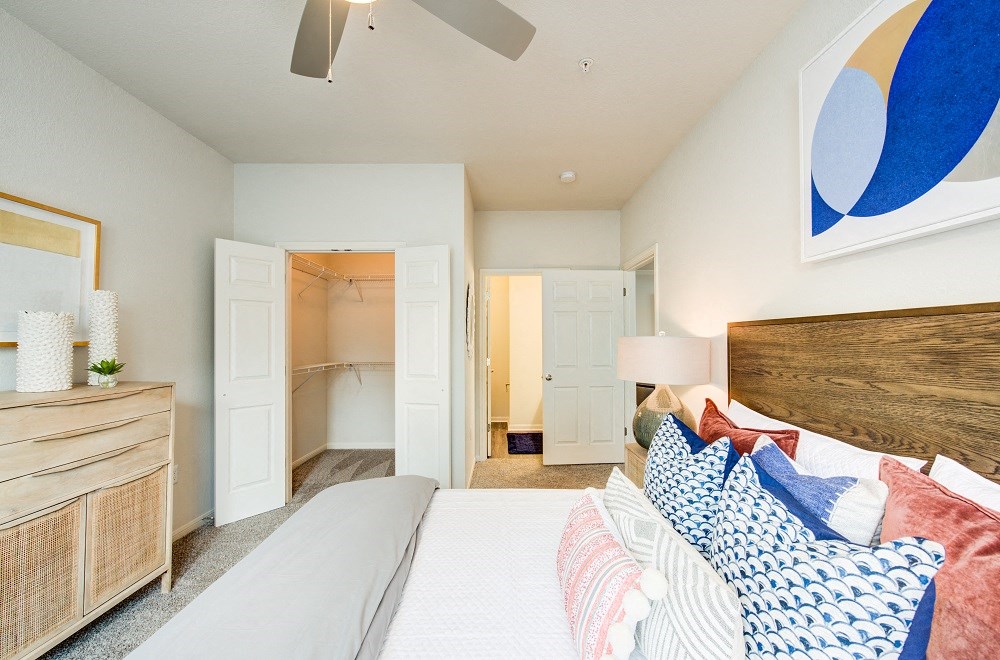 a bedroom with a large bed and a ceiling fan